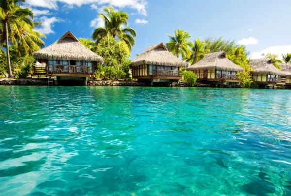 A group of houses on stilts in the water.