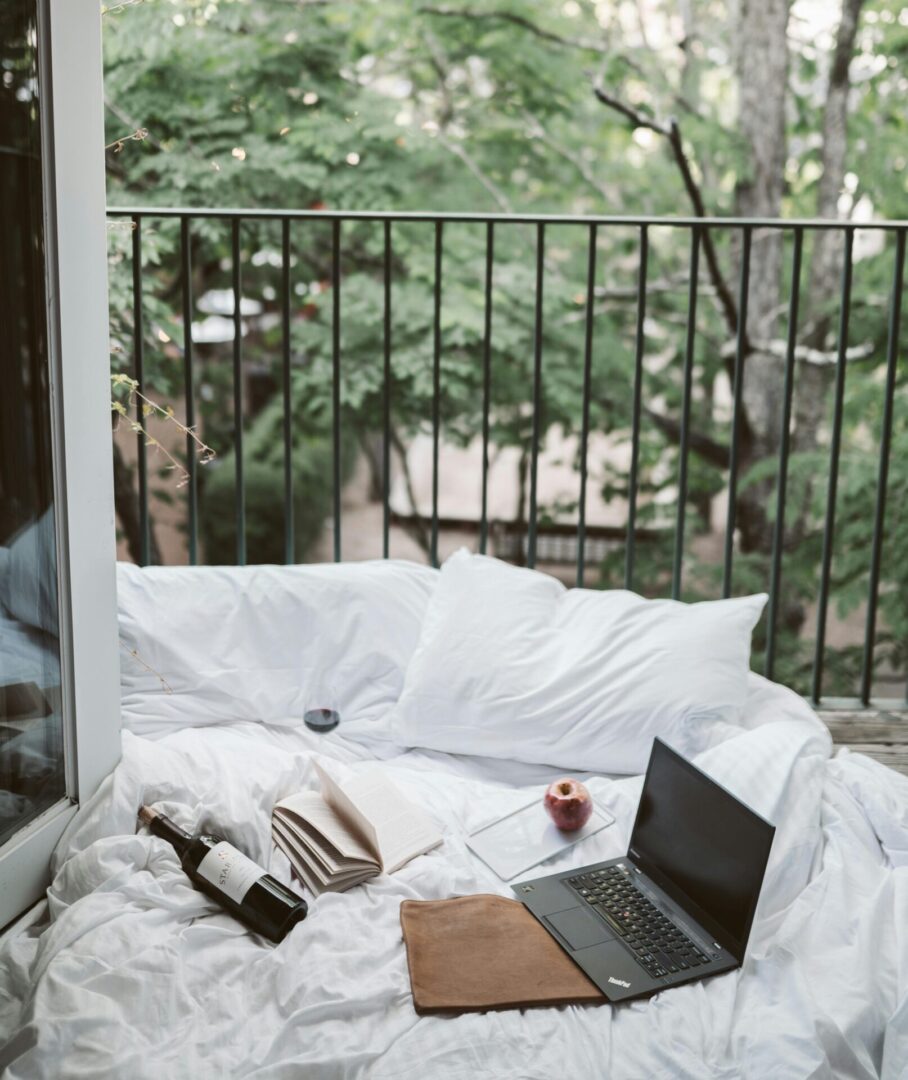 A laptop and wine glasses on the balcony